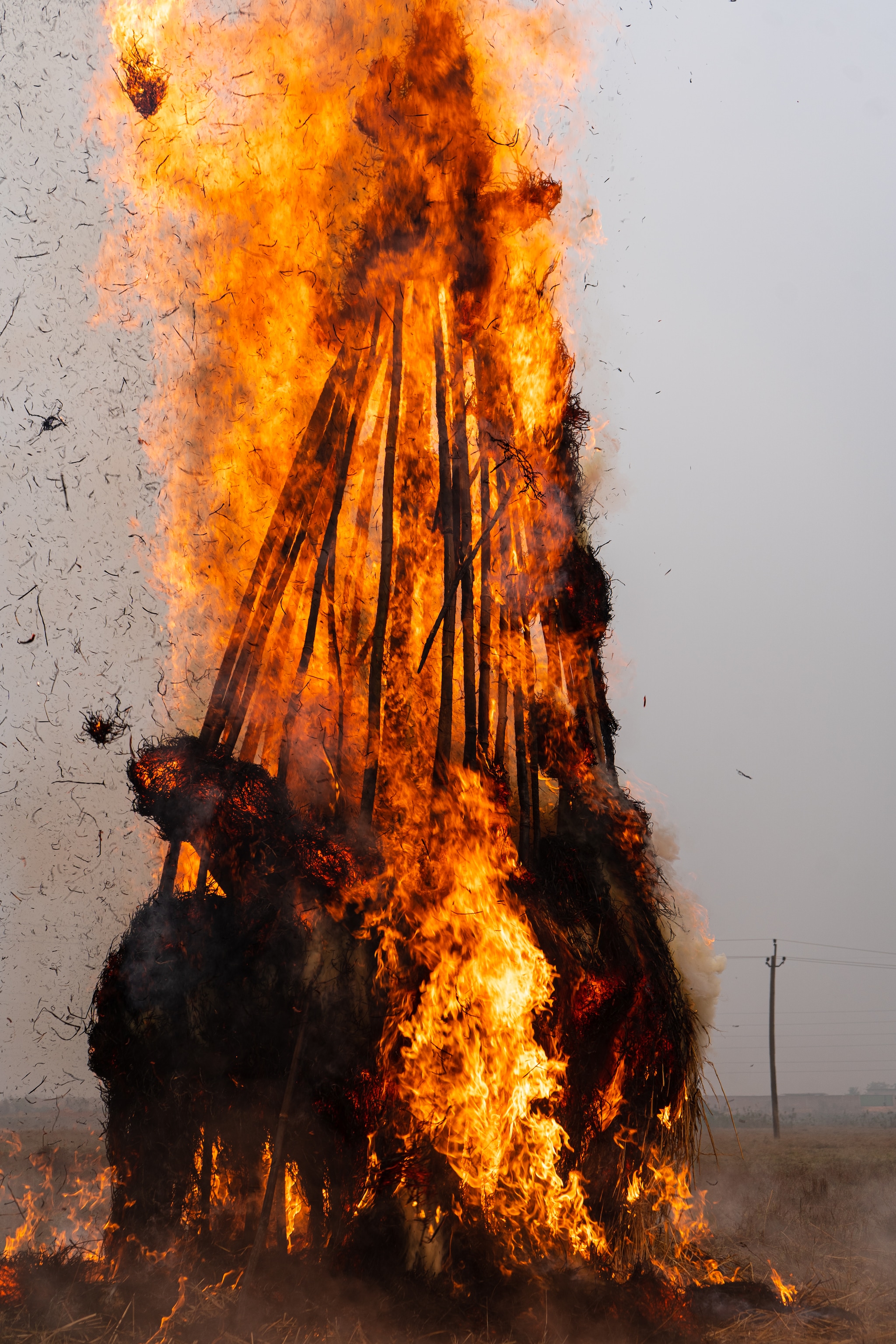 As the Meji burns, people chant ceremonial Assamese prayers and pay special respect to elders. (Image: Uddipta Deka) As the Meji burns, people chant ceremonial Assamese prayers and pay special respect to elders. (Image: Uddipta Deka)