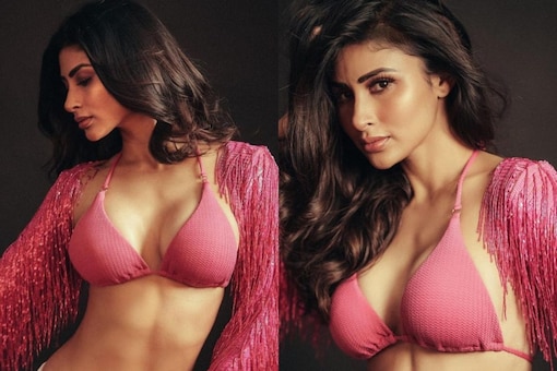 Mouni Roy flaunting her abs in a sizzling pink bralette.