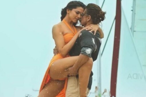 In this image, Deepika Padukone and Shah Rukh Khan get cosy during Pathaan song Besharam Rang.
