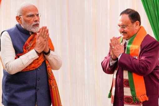 PM Modi with BJP National President JP Nadda as he arrives for the second day of BJP's National Executive Meet, at NDMC Convention Centre in New Delhi, on Tuesday.  (PTI) 