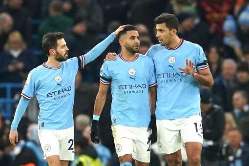 Manchester City's Riyad Mahrez, centre, celebrates with teammates after scoring his side's third goal during the English Premier League soccer match between Manchester City and Aston Villa at the Etihad Stadium in Manchester, England, Sunday, Feb. 12, 2023. (AP Photo/Dave Thompson)
