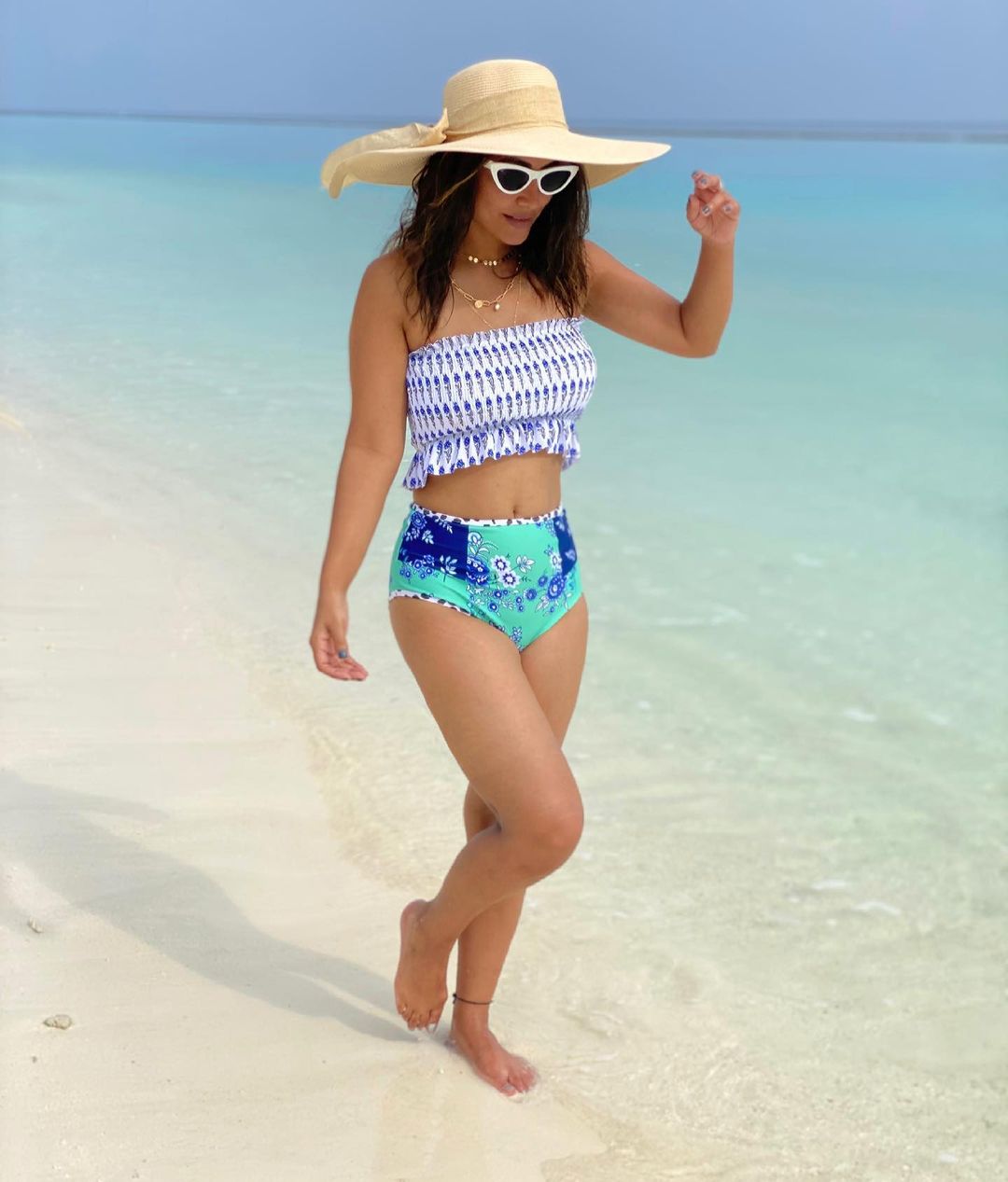 Hina Khan looks stylish in a bandeau bikini top and printed bottoms. 
