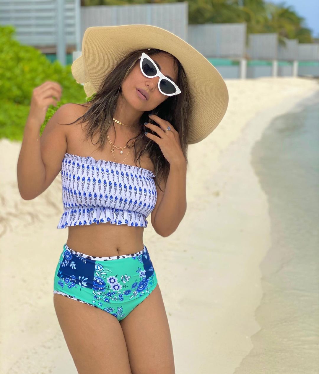 Hina Khan accessories the bikini with a hat and shades.