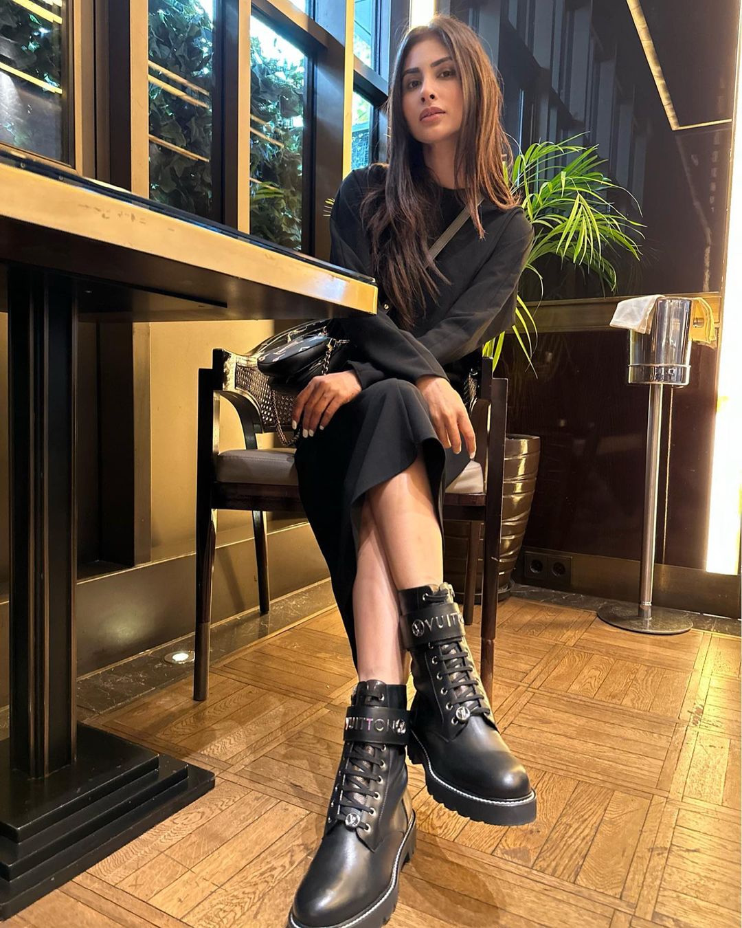 Mouni Roy looks chic in a black turtleneck dress.