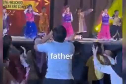 Man dances along with his daughter to Daler Mehndi song.