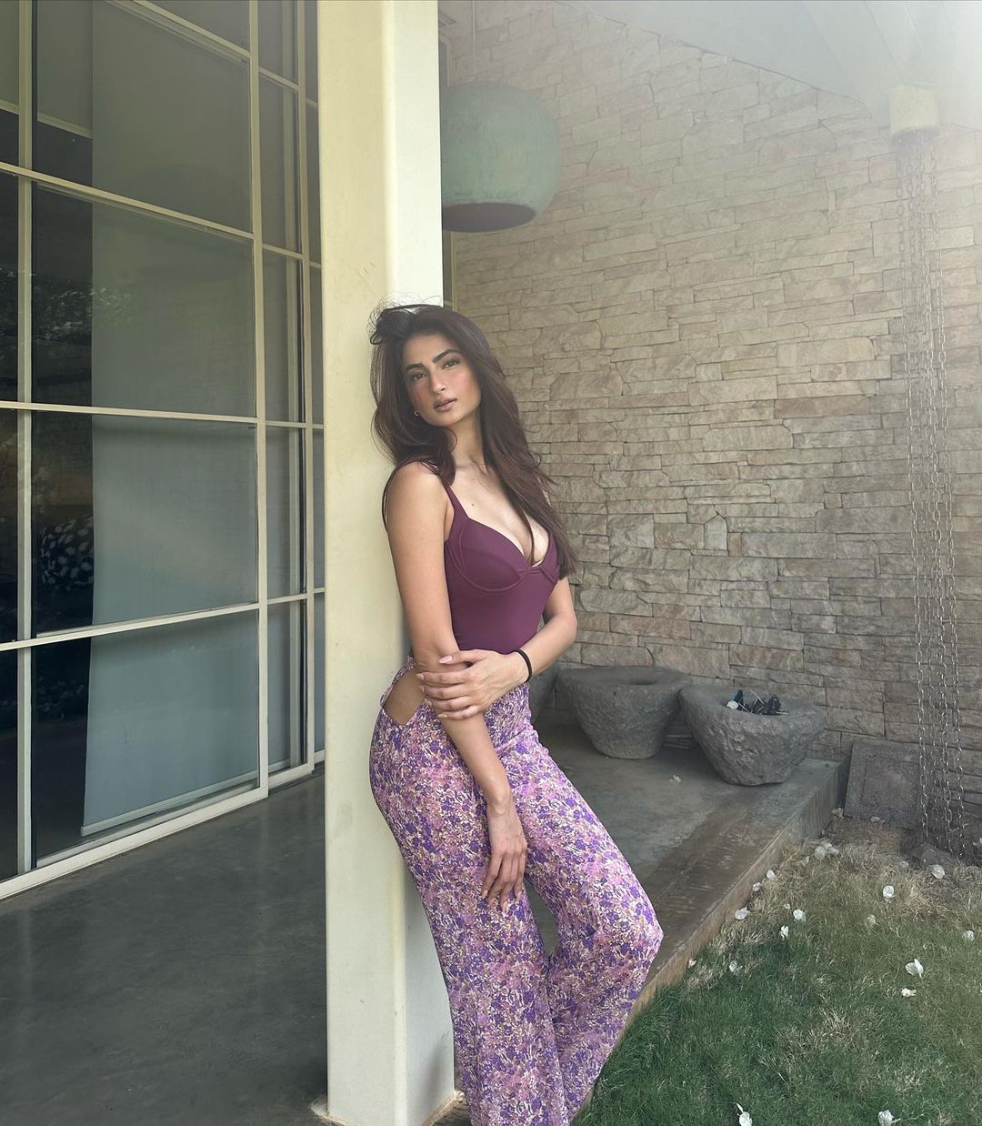 Palak Tiwari pairs the bold purple top with printed purple pajamas. 