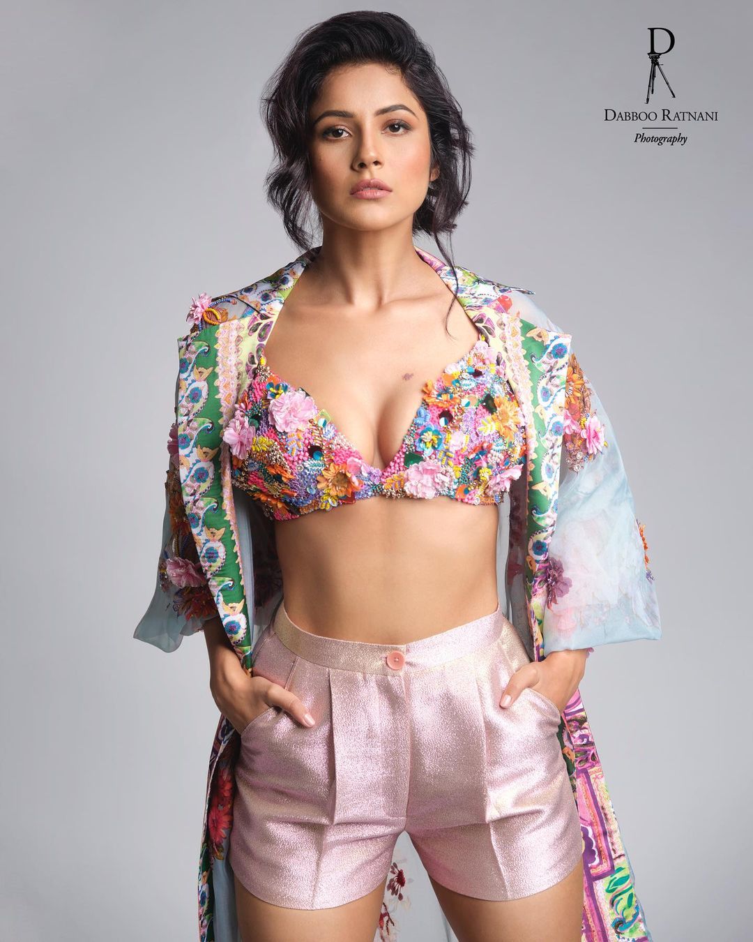 Shehnaaz Gill looks hot in the floral bralette worn with pink silk shorts. 