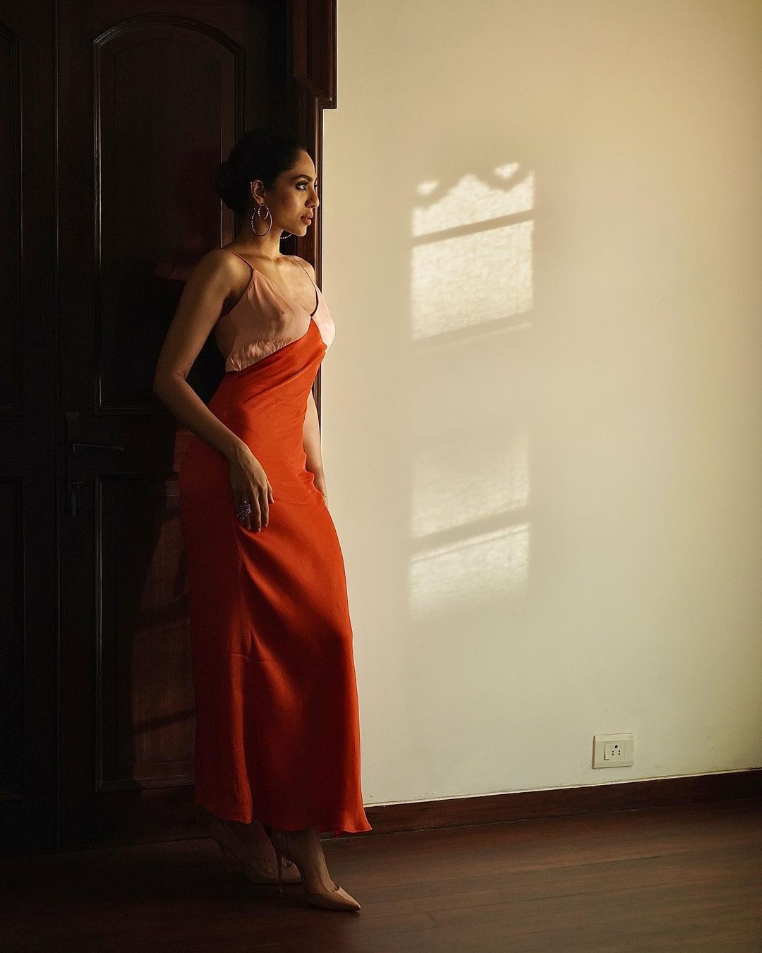 Sobhita Dhulipala looks stunning in an orange floor-length dress. 