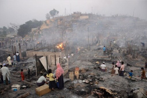 Rohingya refugees search for their belongings after a fire broke out in Balukhali refugee camp in Ukhia on March 5, 2023. (AFP)