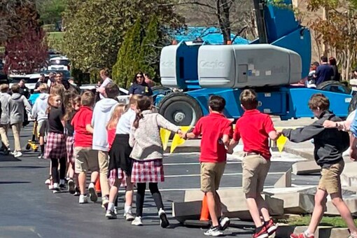 Children from The Covenant School, a private Christian school in Nashville, Tenn., hold hands as they are taken to a reunification site after a shooting at their school (Image: AP)