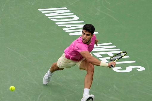 Carlos Alcaraz returns a service during his semifinal clash with Jannik Sinner (AP Photo)