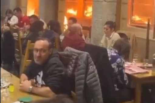 France restaurants diners embody 'This is fine' meme amid fire. (Credits: Twitter/@Risemelbourne)