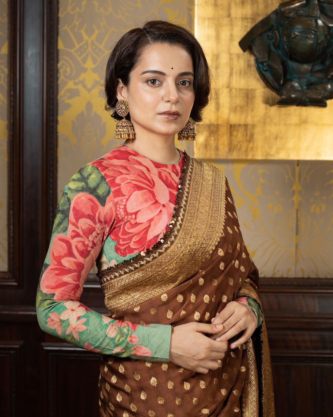 Not the one to shy away from making bold opinions, Kangana’s personality reflects in her fashion sense too. Take a look at this beautiful brown saree that the diva teamed with a floral full-sleeve blouse. (Image: Instagram) Not the one to shy away from making bold opinions, Kangana’s personality reflects in her fashion sense too. Take a look at this beautiful brown saree that the diva teamed with a floral full-sleeve blouse. (Image: Instagram)