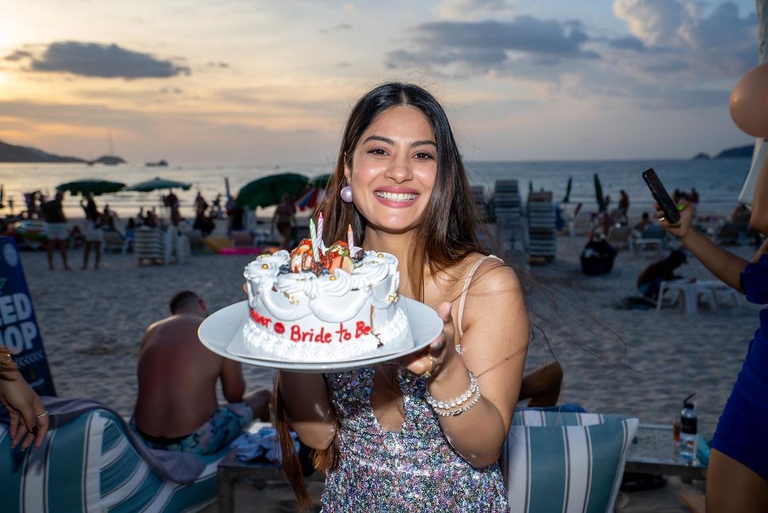 Krishna Mukherjee poses with her 'bride-to-be' cake on the beach.