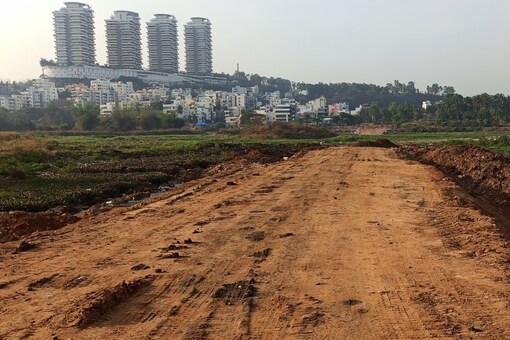 Residents allege the 25-feet-wide road through the Hosakerehalli Lake in Bengaluru's RR Nagar is to provide access to and benefit a luxury project coming up nearby. (News18)