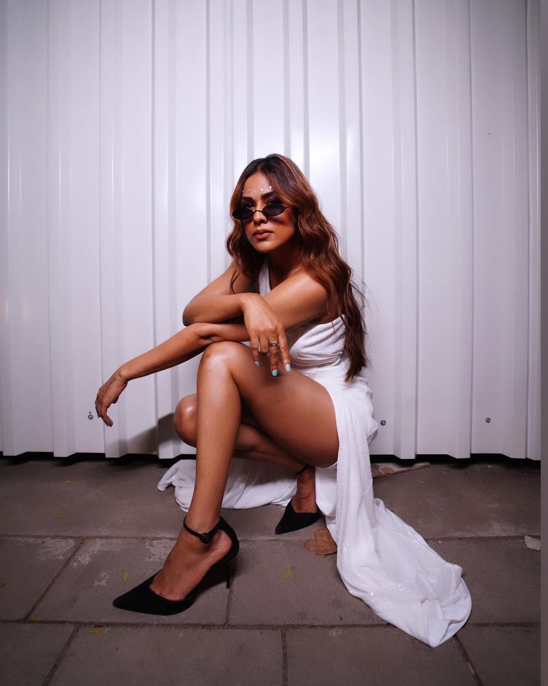 Nia Sharma looks cool in a white flowy dress. 
