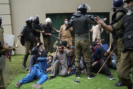 Police detain supporters of former Prime Minister Imran Khan during a search operation in the Khan's resident, in Lahore, Pakistan, March 18, 2023. Pakistani police stormed former Prime Minister Khan's residence in the eastern city of Lahore on Saturday and arrested 61 people amid tear gas and clashes between Khan's supporters and police, officials said. AP