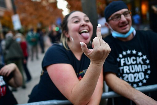 A political activist gestures with the middle finger towards other activists at a protest site (Image: Reuters/Representative)