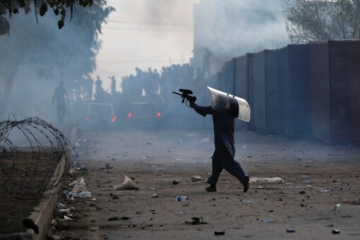 A police officer uses a paintball gun to disperse supporters of former Pakistani Prime Minister Imran Khan during a clash outside Federal Judicial Complex in Islamabad, Pakistan (Image: Reuters)