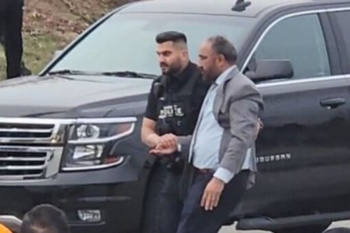 Surtej Gill is being escorted by Surrey’s police officers as he sustained injuries after a Khalistani separatist mob attacked him at a diaspora event (Image: Siddhant Mishra/SOURCED)