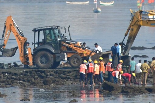 Bulldozers being used to demolish illegal construction during a demolition drive by the BMC at Mahim beach, in Mumbai on Thursday. (Image: PTI)