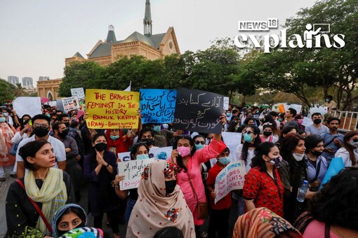 People carry signs and chant slogans as they participate in Aurat March or Women's March, to mark the International Women's Day in Karachi, Pakistan March 8, 2021. REUTERS/Akhtar Soomro