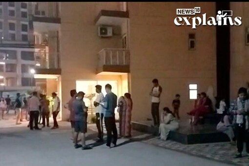  New Delhi: People gather after a building tilts following an earthquake, in New Delhi, Tuesday, March 21, 2023. (PTI Photo)