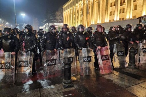 Georgian riot police stand outside Georgia's Parliament in Tbilisi early on March 9, 2023 during a rally called by Georgian opposition and civil society groups against a planned foreign agent law reminiscent of Russian legislation used to silence critics. (AFP)