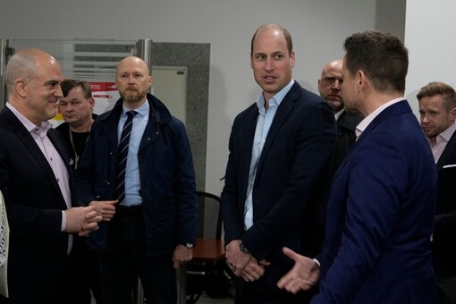 Britain's Prince William, center, talks to Mayor of Warsaw Rafal Trzaskowski, right, as they visit an accommodation centre, for Ukrainians who fled the war, in Warsaw, Poland. (AP)