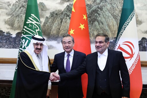 Chinese leader Wang Yi, Iran’s security official Ali Shamkhani, and Saudi security adviser Musaad bin Mohammed Al Aiban pose for pictures during a meeting in Beijing, China March 10, 2023. (Image: Reuters)

