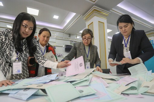 Members of a local election committee count ballots after polls closed during parliamentary election in Almaty, Kazakhstan, March 19, 2023. (Image: Reuters)