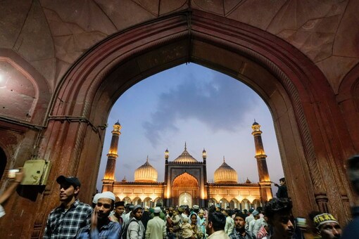 Muslims visit Jama Masjid ahead of the festival of Eid, in Delhi, Friday. (PTI Photo)
