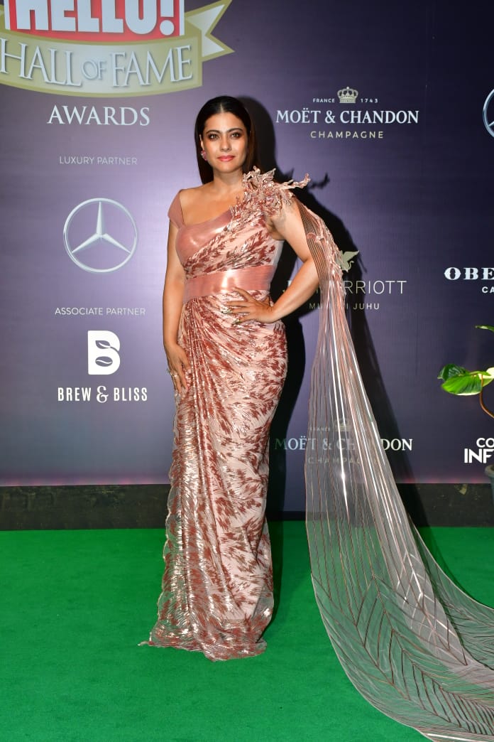 Kajol looks stunning in a shiny cape gown at Hello Hall of Fame Awards 2023.