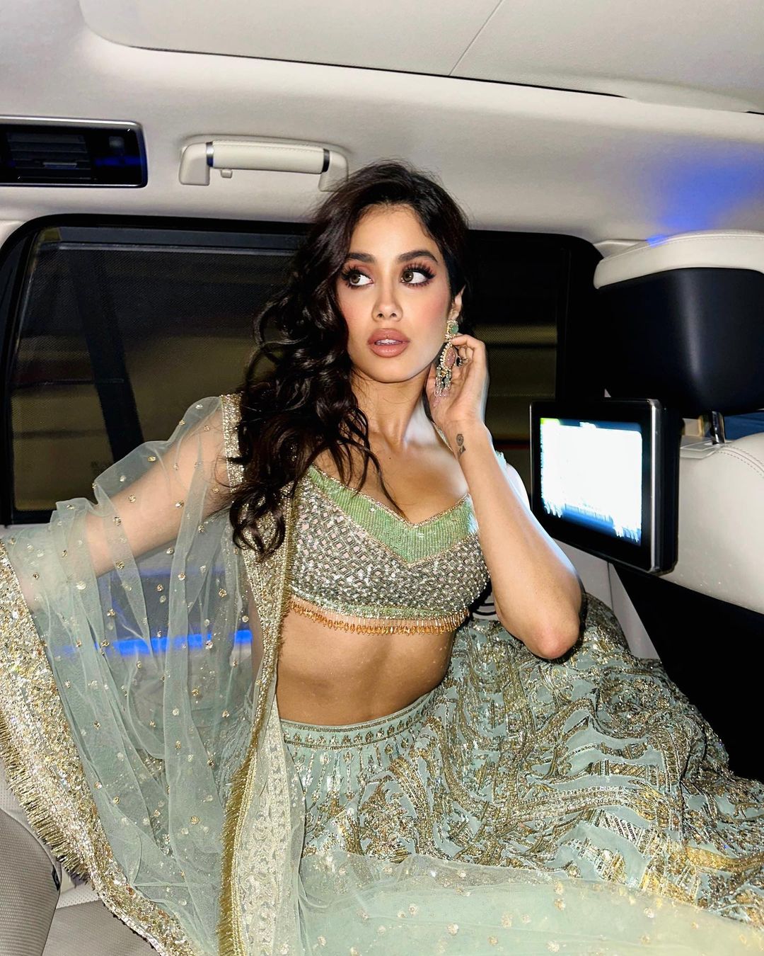 Janhvi Kapoor looks stunning in a green shimmery lehenga. 