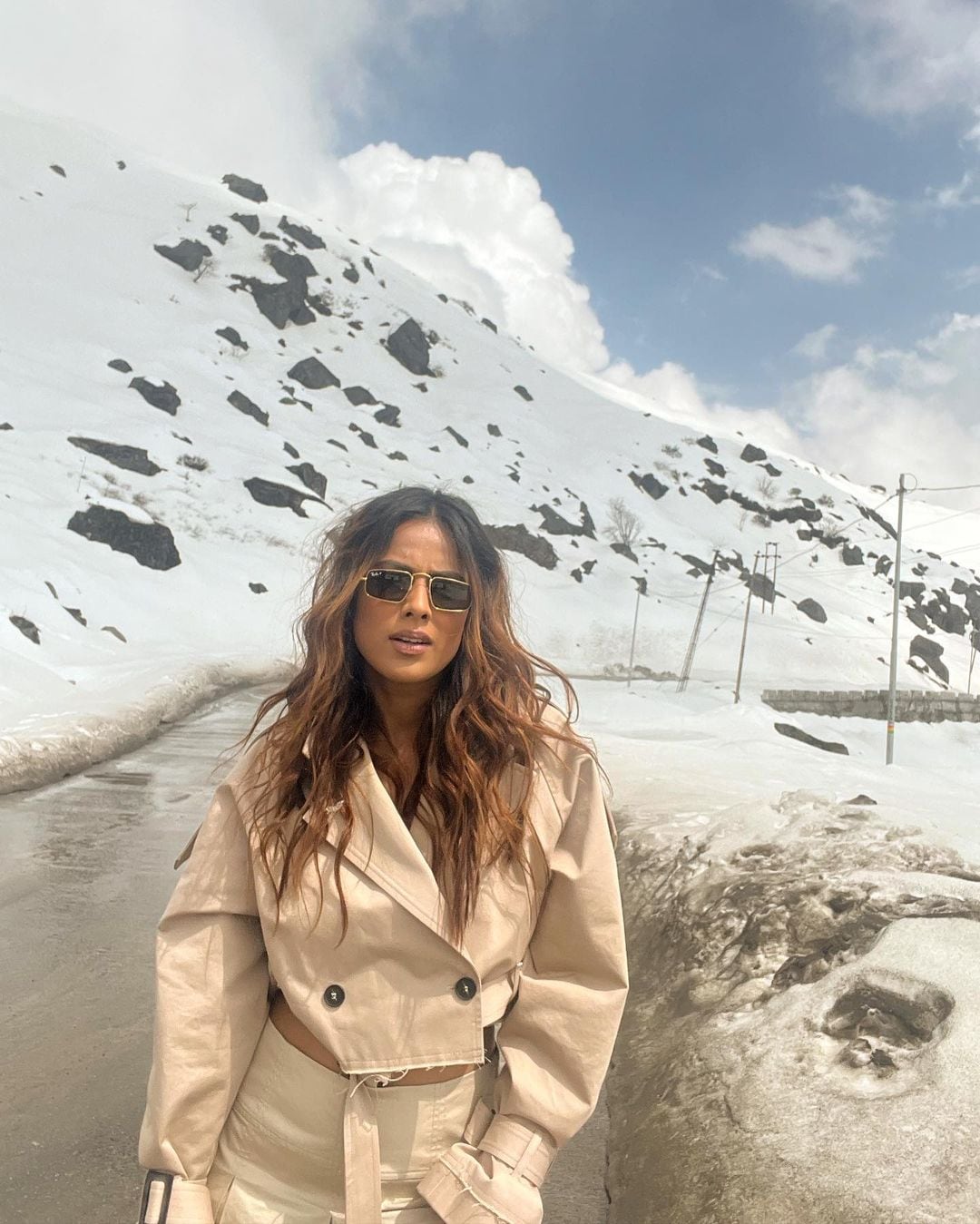 Nia Sharma strikes a pose against the snow-clad mountains. 