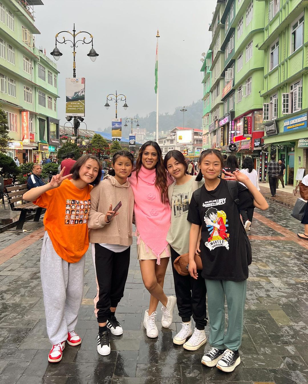 Nia Sharma poses with a group of young local girls. 