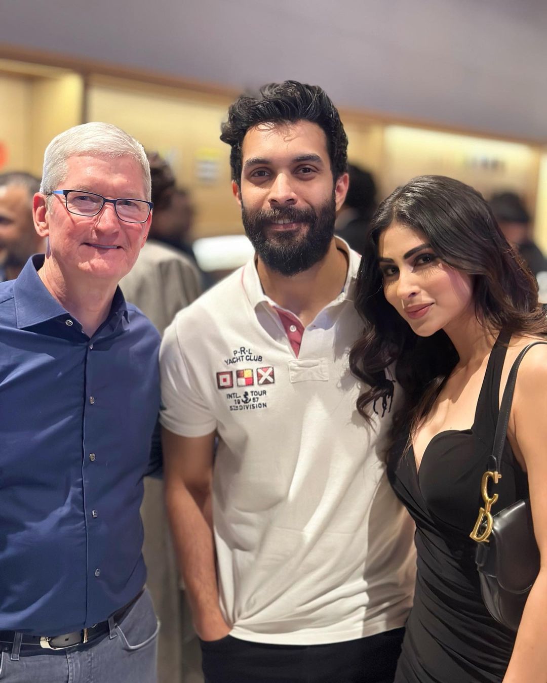 Tim Cook gets clicked with Mouni Roy and her husband Suraj Nambiar. 
