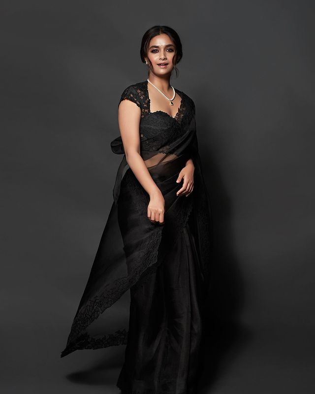 Keerthy Suresh passes retro vibes in a black saree with the lace blouse. 