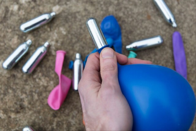 Police Catch Man Inhaling Laughing Gas from Balloon. Find 48,000 Cans ...