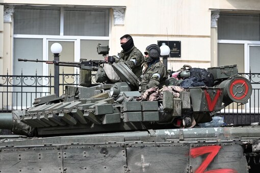 Fighters of Wagner private mercenary group are seen atop of an armoured vehicle in a street near the headquarters of the Southern Military District in the city of Rostov-on-Don, Russia. (Image: Reuters)