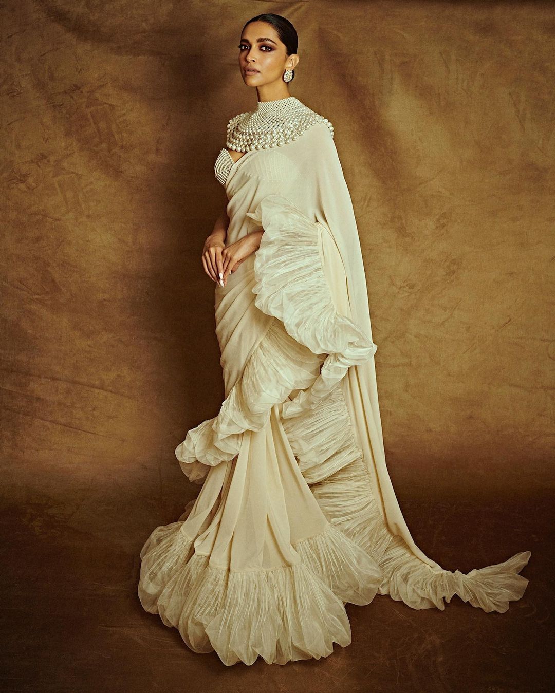Cannes 2022 saw some of Deepika's best all-time looks. This ivory ruffled saree and strapless pearl blouse. The Abu Jani Sandeep Khosla ensemble is one to die for. (Image: Instagram) Cannes 2022 saw some of Deepika's best all-time looks. This ivory ruffled saree and strapless pearl blouse. The Abu Jani Sandeep Khosla ensemble is one to die for. (Image: Instagram)