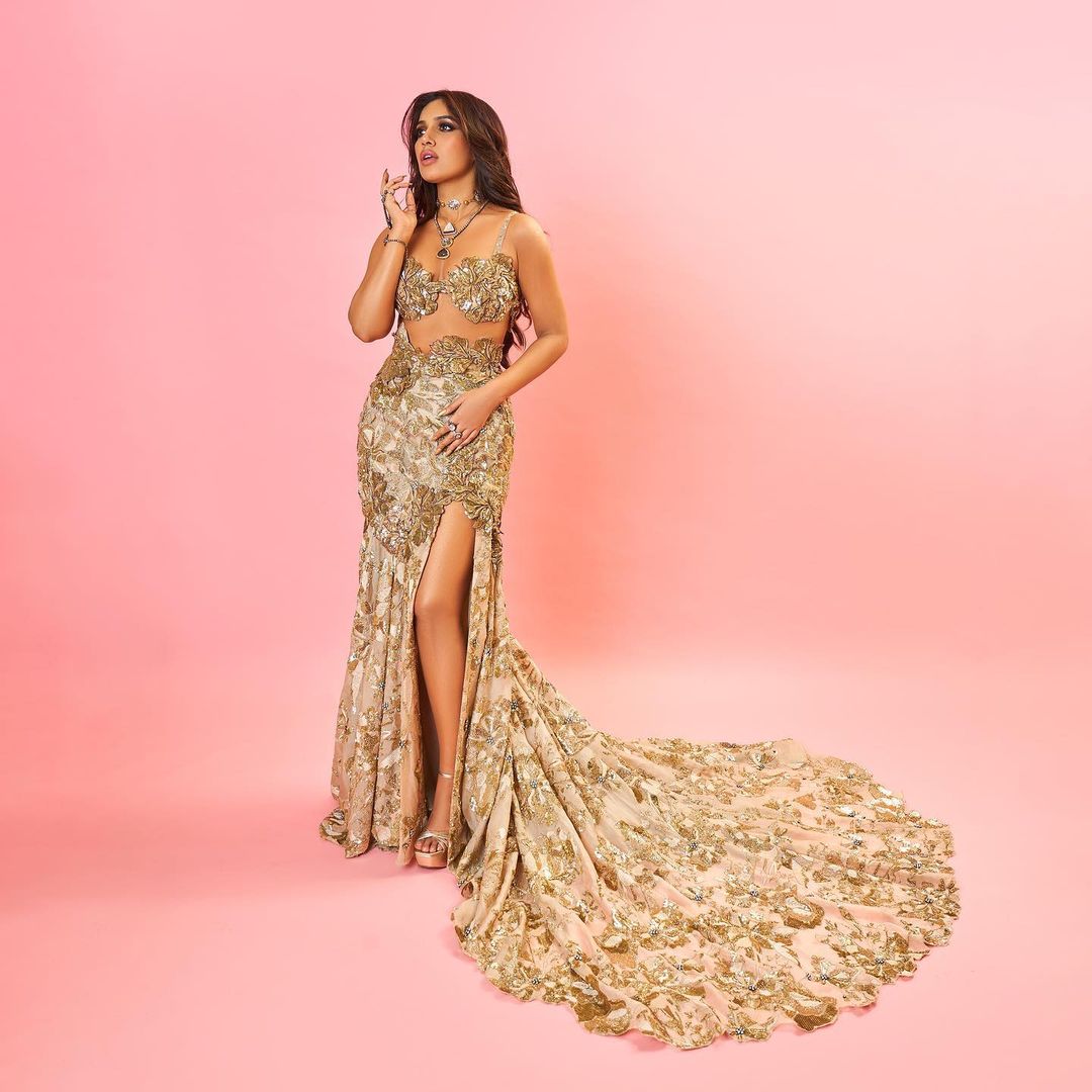 Bhumi Pednekar is a golden goddess in designer Varun Bahl's outfit. She oozes oomph in a golden strappy bralette, paired with a fish-cut thigh-high slit skirt. (Image: Instagram) Bhumi Pednekar