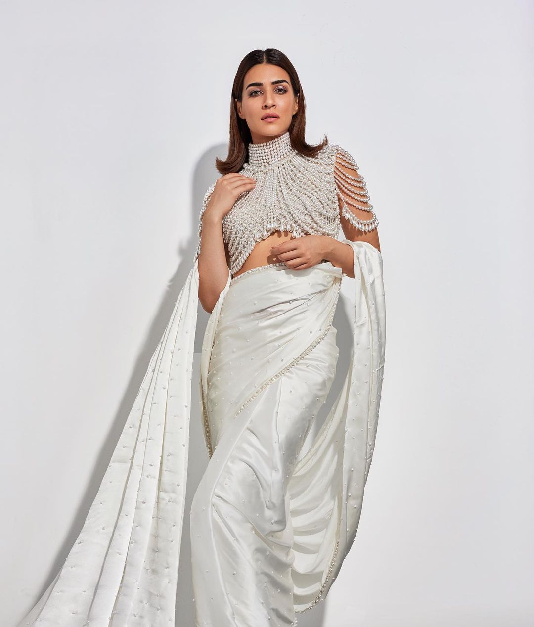 Kriti Sanon's attire as Manish Malhotra's muse left us looking for our jaws on the floor. Her breathtakingblouse, adorned entirely with pearls, stole the show. Paired with an elegant ivory saree, Kriti’s OOTD was a perfect balance between glamorous and ethnic. In this gorgeous number, the actress was a sight to behold. (Image: Instagram)