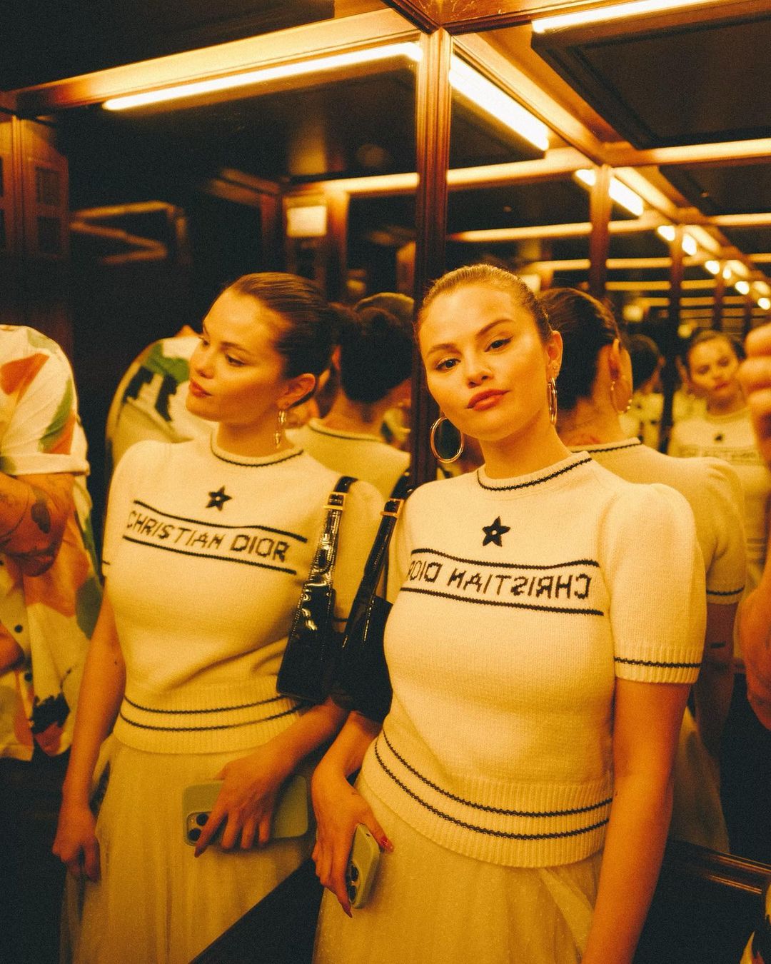 Selena Gomez exuded sheer glamour, adorned in an exquisite Christian Dior short-sleeve sweater paired flawlessly with a mesmerizing midi skirt featuring delightful pleats. The attention to detail in her ensemble was impeccable, as she effortlessly tied her look together with a sleek and elegant hairstyle. (Image: Instagram) Selena Gomez exuded sheer glamour, adorned in an exquisite Christian Dior short-sleeve sweater paired flawlessly with a mesmerizing midi skirt featuring delightful pleats. The attention to detail in her ensemble was impeccable, as she effortlessly tied her look together with a sleek and elegant hairstyle. (Image: Instagram)