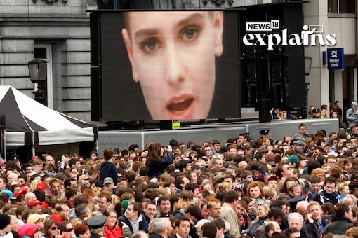 A music video of Irish singer Sinead O'Connor plays over a crowd. (Reuters/FILE)