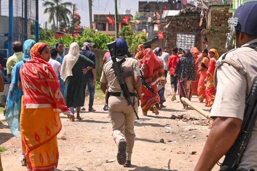 Police try to maintain law and order after a clash between rival political groups during panchyat elections, at Nagaria village in Malda district. (Image: PTI)