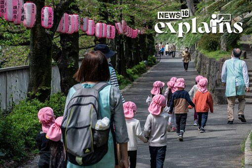 This photo taken on April 5, 2023 shows young children being escorted through a park during an outing in Tokyo. (AFP)
