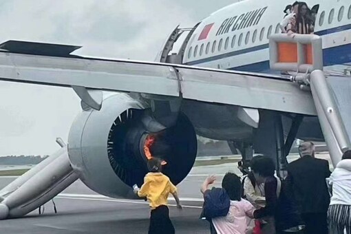Passengers leave Air China flight whose engine caught fire through an emergency slide in Singapore airport. (Image: X/@Alpha_N_)