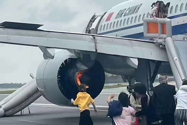 Passengers leave Air China flight whose engine caught fire through an emergency slide in Singapore airport. (Image: X/@Alpha_N_)
