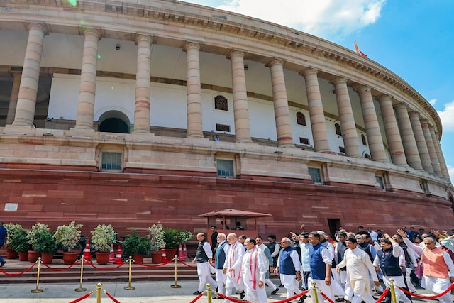Parliamentarians walks towards the new Parliament building, in New Delhi.

(Image: News18)